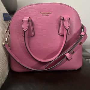 This is a beautiful pink leather Kate Spade purse with gold hardware